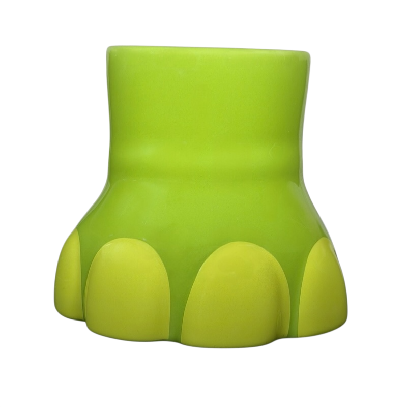 The Good Dinosaur Arlo Spot mug in vibrant green with a dinosaur footprint design