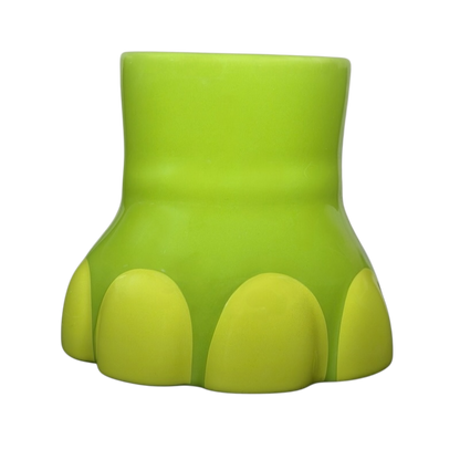 The Good Dinosaur Arlo Spot mug in vibrant green with a dinosaur footprint design