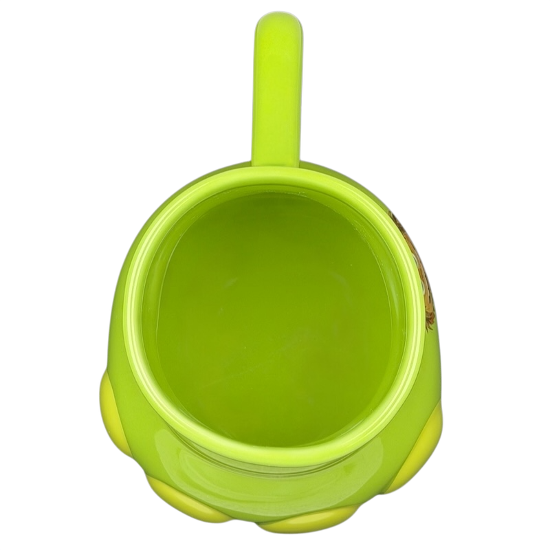Top view of The Good Dinosaur Arlo Spot mug featuring a bright green design and round body
