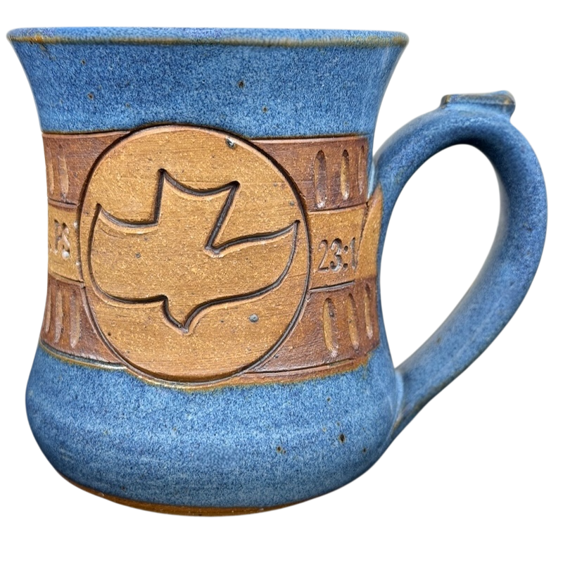 The Lord is My Shepherd pottery mug with a dove design and blue glaze finish