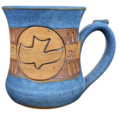 The Lord is My Shepherd pottery mug with a dove design and blue glaze finish