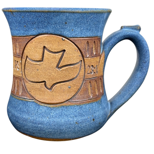 The Lord is My Shepherd pottery mug with a dove design and blue glaze finish