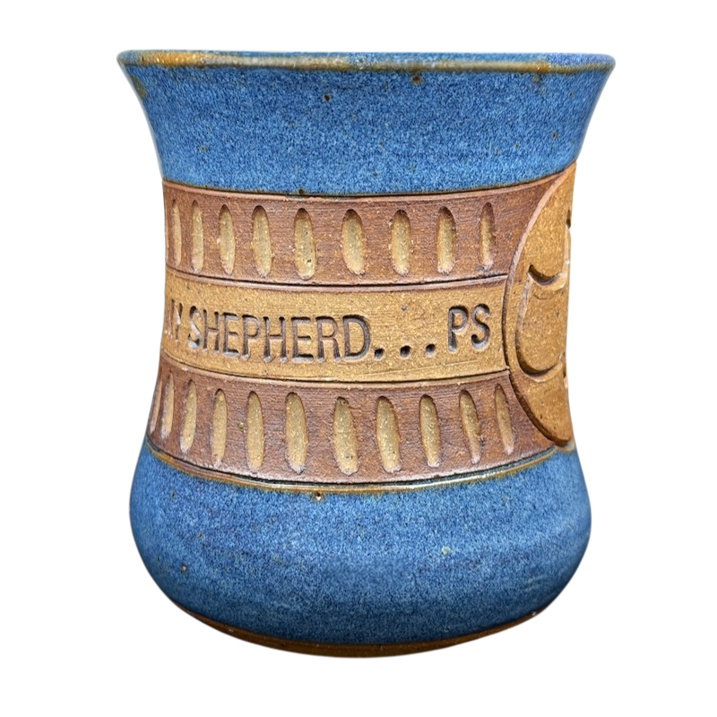 Handcrafted pottery mug featuring 'The Lord is My Shepherd' design in blue and brown colors