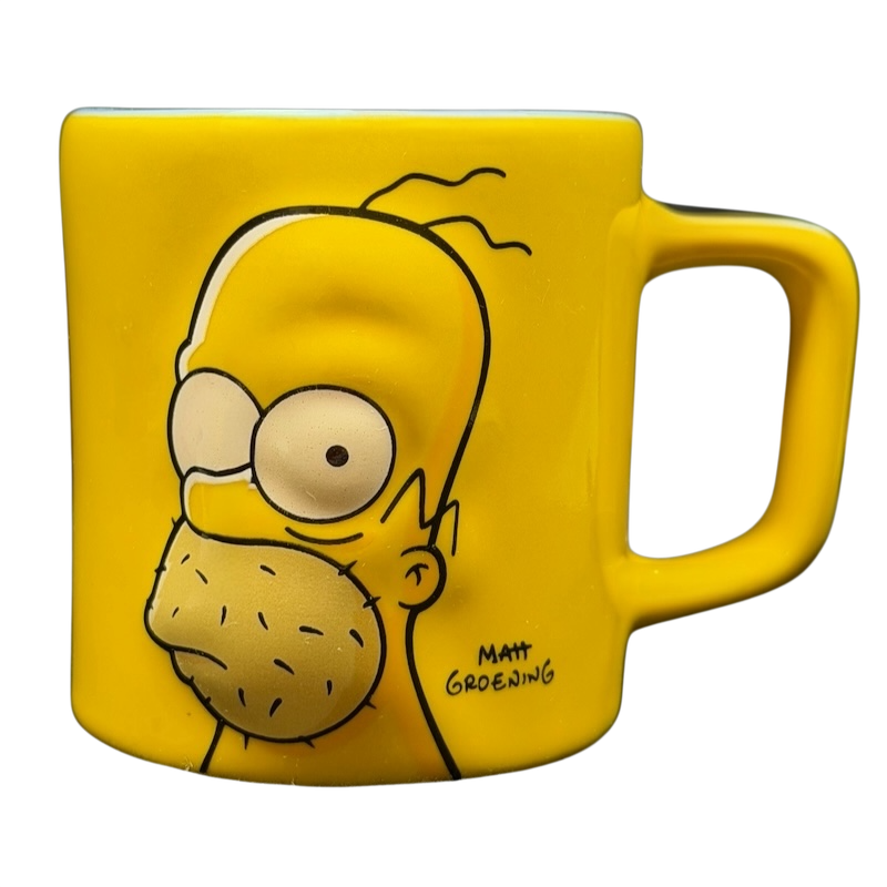 The Simpsons Homer Simpson Not-So-Hot Shot Universal Studios Mini Mug featuring a bright yellow design