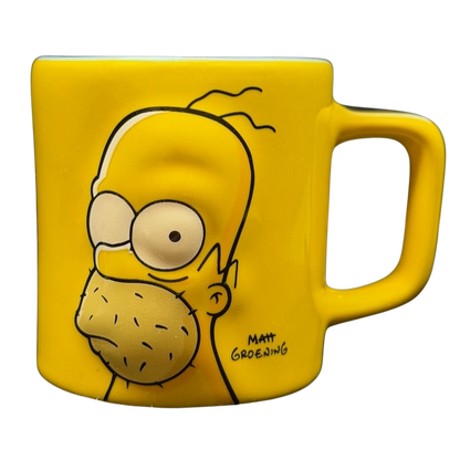 The Simpsons Homer Simpson Not-So-Hot Shot Universal Studios Mini Mug featuring a bright yellow design
