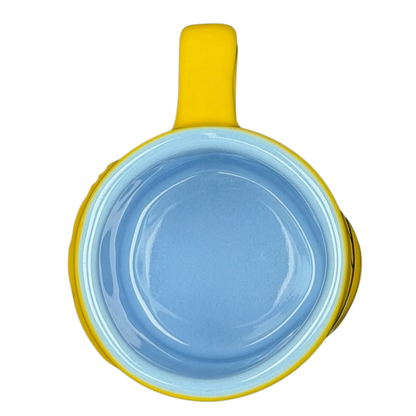 The Simpsons Homer Simpson Not-So-Hot Shot Universal Studios Mini Mug in yellow and blue with a smooth finish