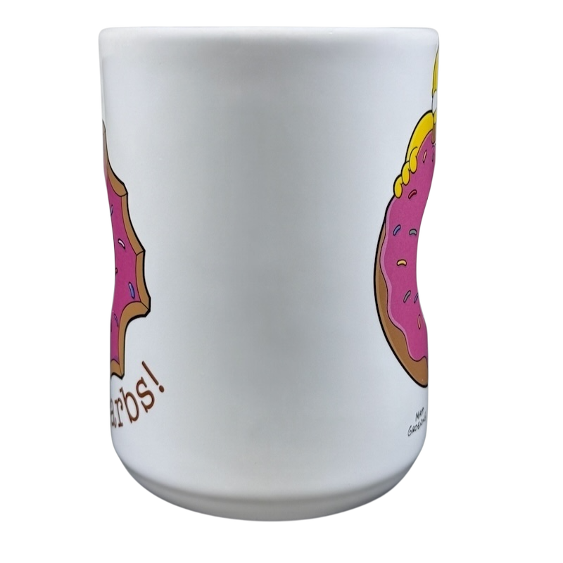 The Simpsons Homer Universal Studios donut mug featuring Homer holding a pink donut