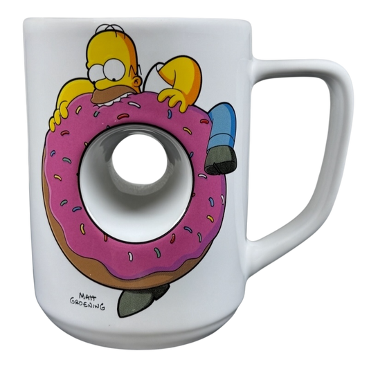The Simpsons Homer Universal Studios donut mug featuring Homer Simpson holding a large pink donut