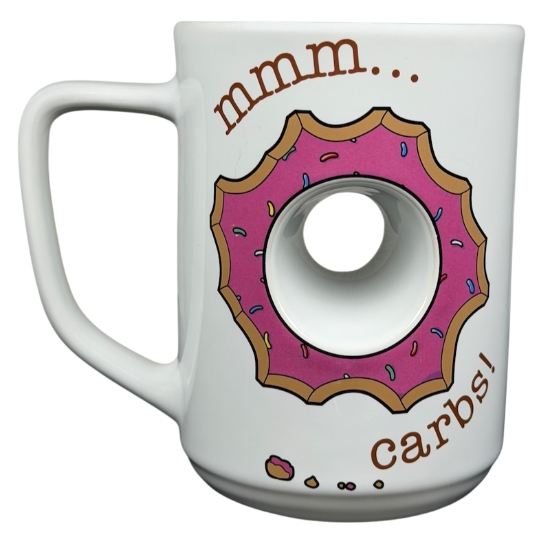 The Simpsons Homer Universal Studios donut mug featuring a donut design and the text mmm carbs