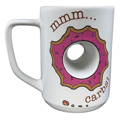 The Simpsons Homer Universal Studios donut mug featuring a pink donut design with the text mmm... carbs!