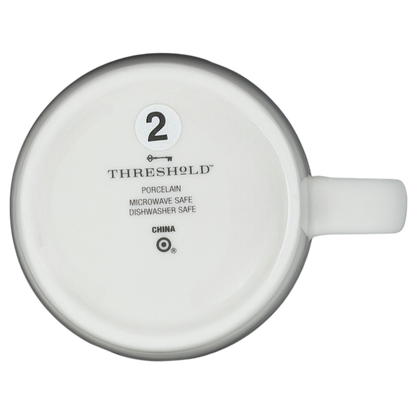 Bottom view of a Threshold PISCES Astrology Zodiac Mug featuring dishwasher and microwave safety instructions