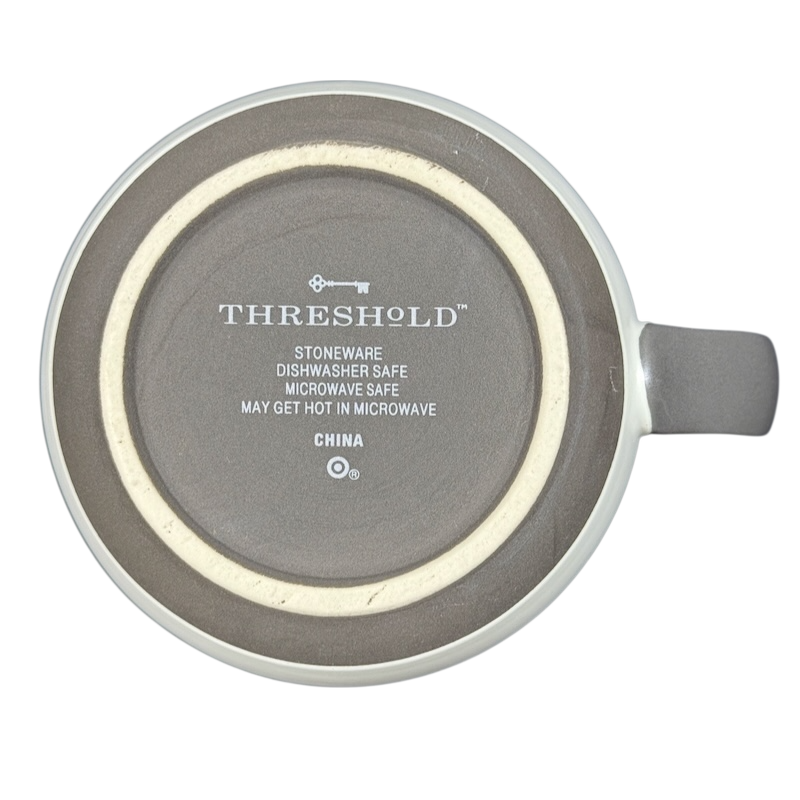 Bottom view of Threshold monogram initial cream P mug showing Threshold logo and care text