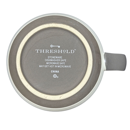 Bottom view of Threshold monogram initial cream P mug showing Threshold logo and care text