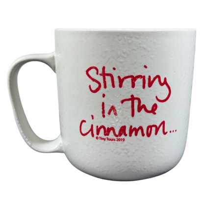 White textured ceramic mug with red handwritten Stirring in the cinnamon text on front Sara Bareilles tour mug