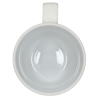 Top view of white ceramic Sara Bareilles tour mug empty glossy interior with handle on black background