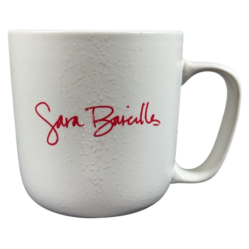 White textured ceramic Sara Bareilles tour mug with red signature script and right handle