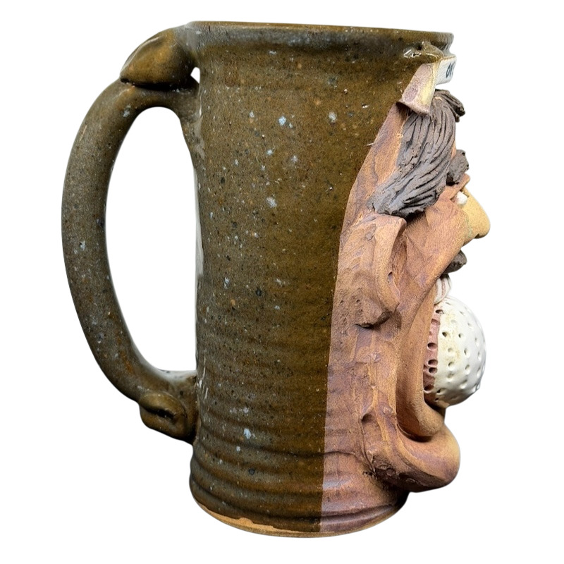 Unique ugly face pottery golf mug featuring a textured design and a creative golf ball detail