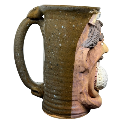 Unique ugly face pottery golf mug featuring a textured design and a creative golf ball detail