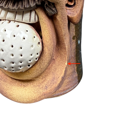 Unique ugly face pottery golf mug featuring a whimsical design with a textured finish