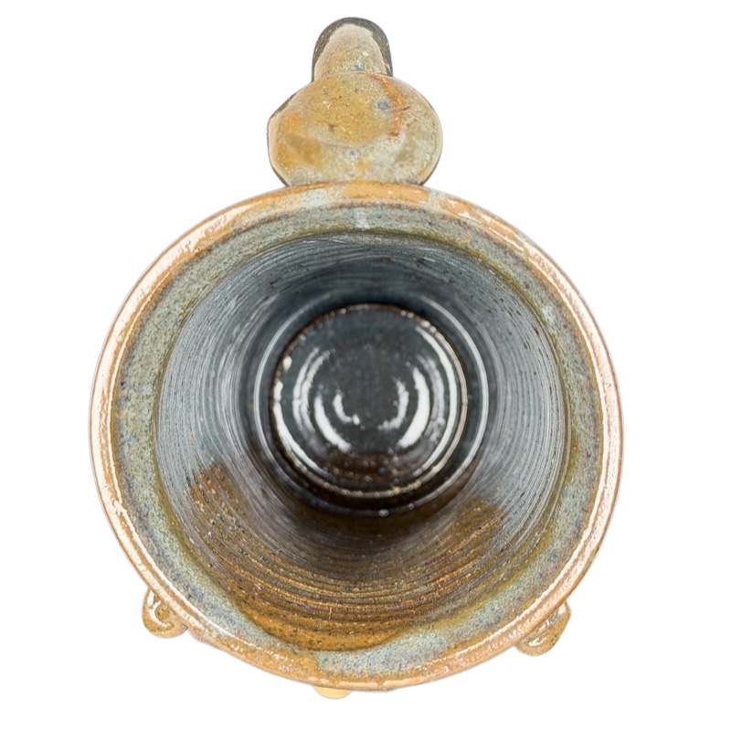 Inside view of an ugly face pottery golf mug with a unique textured finish and rustic colors