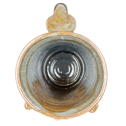 Inside view of an ugly face pottery golf mug with a unique textured finish and rustic colors