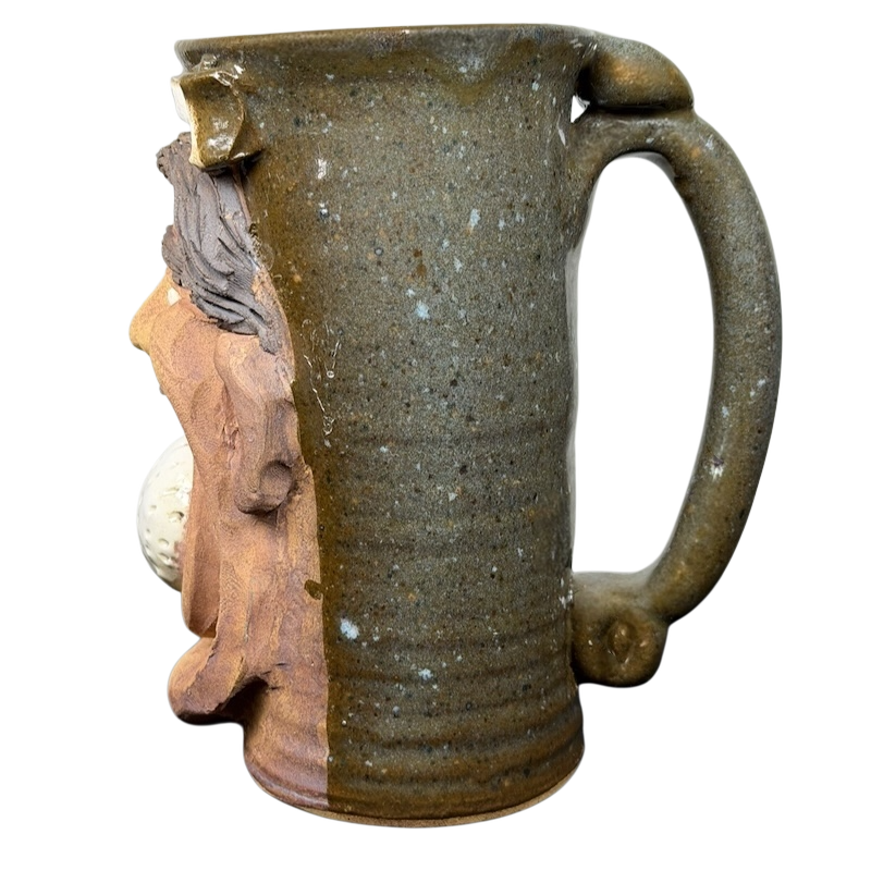 Unique ugly face pottery golf mug featuring a sculpted design and sturdy handle