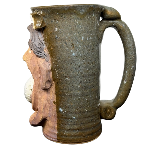 Unique ugly face pottery golf mug featuring a sculpted design and sturdy handle