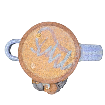 Bottom view of Ugly Face Pottery Man With Moustache And Tongue Mug Mahon Made Stoneware showcasing unique design and texture