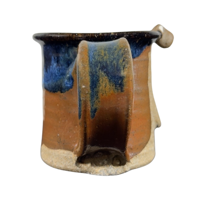 Ugly face pottery vintage winking mug with unique brown and blue glaze and artistic handle design