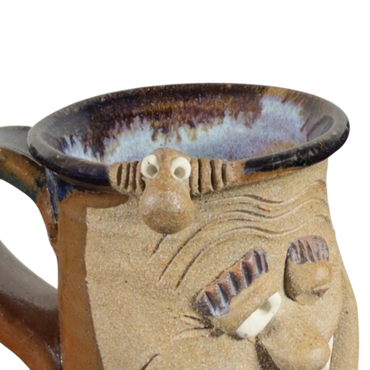 Ugly face pottery vintage winking mug with textured ceramic and playful facial expression