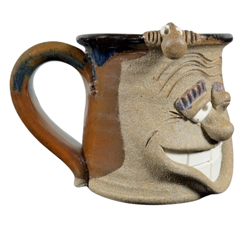 Ugly face pottery vintage winking mug with textured brown and beige ceramic and exaggerated facial features