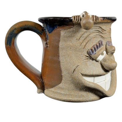 Ugly face pottery vintage winking mug with textured brown and beige ceramic and exaggerated facial features