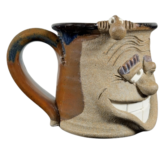 Ugly face pottery vintage winking mug with textured brown and beige ceramic and exaggerated facial features