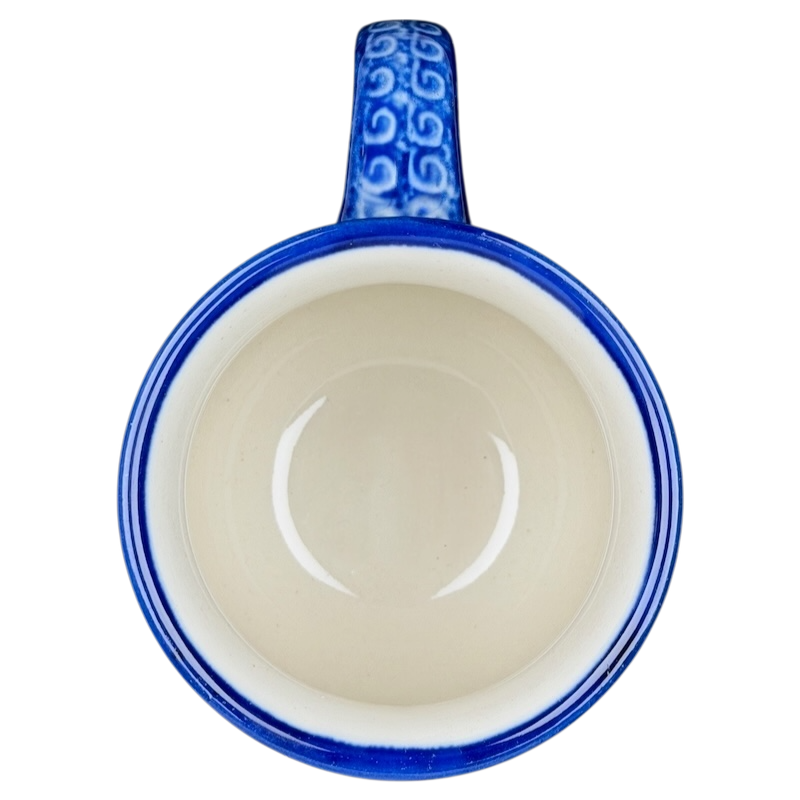 Unikat Boleslawiec Blue Floral mug with an intricate blue handle and smooth cream interior