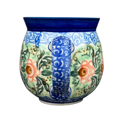 Unikat Polish pottery Boleslawiec mug with vibrant floral design and curved handle