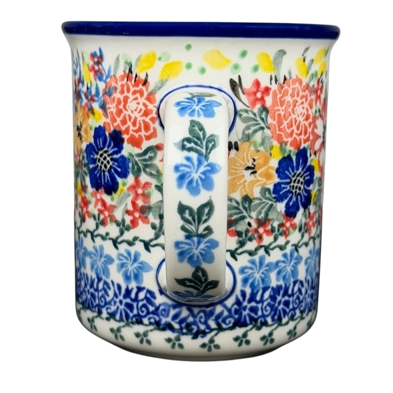 Colorful Unikat Polish pottery hummingbird mug with vibrant floral designs and a sturdy handle