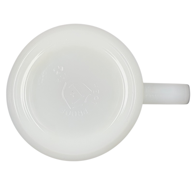 Bottom view of a USS Hancock vintage Fire King mug in glossy white glass with a sturdy handle