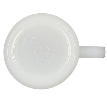 Bottom view of a USS Hancock vintage Fire King mug in glossy white glass with a sturdy handle