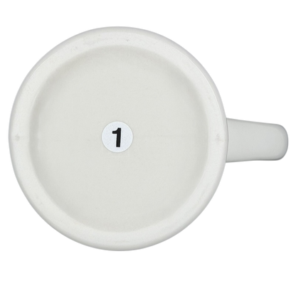 Bottom view of a vintage Bad Dog Wisdom Assert Yourself mug on a black background