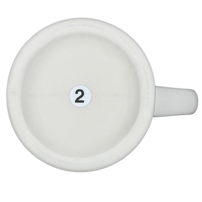 Top view of a vintage Bad Dog Wisdom Defy Authority mug with a clean white ceramic finish