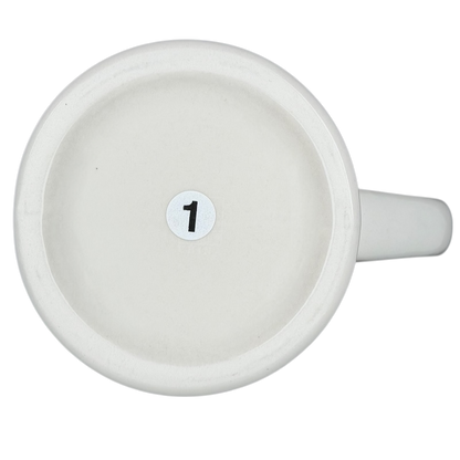 Bottom view of a vintage Bad Dog Wisdom Defy Authority mug showing a numbered base