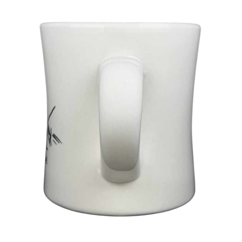 Side view of a vintage Bad Dog Wisdom Learn To Bluff mug in white ceramic with a curved handle