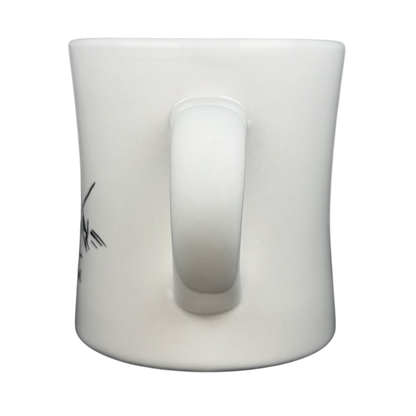 Side view of a vintage Bad Dog Wisdom Learn To Bluff mug in white ceramic with a curved handle