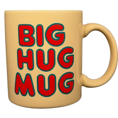 Vintage Big Hug Mug in yellow with bold red and blue lettering for a fun coffee experience