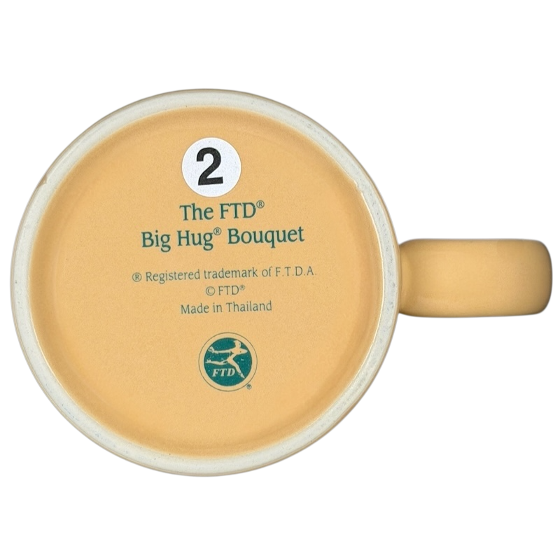 Bottom view of the vintage Big Hug Mug by FTD with a yellow design and branding details