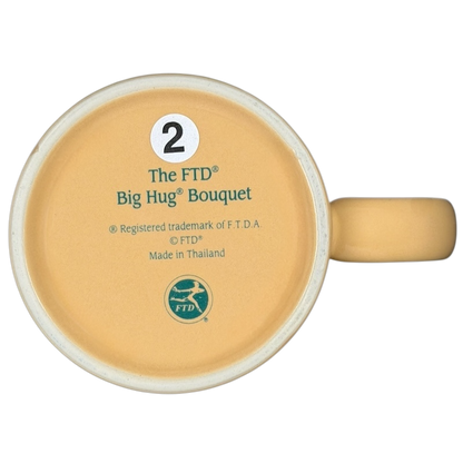 Bottom view of the vintage Big Hug Mug by FTD with a yellow design and branding details