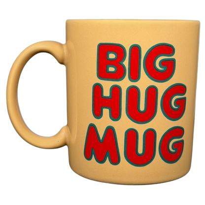 Vintage Big Hug Mug in a yellow color with bold red and green lettering