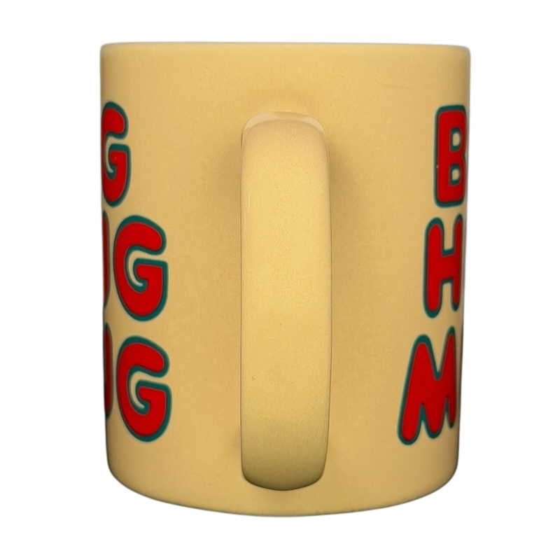 Vintage Big Hug Mug in yellow with colorful text, perfect for cozy drinks