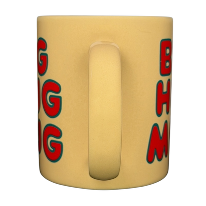 Vintage Big Hug Mug in yellow with colorful text, perfect for cozy drinks