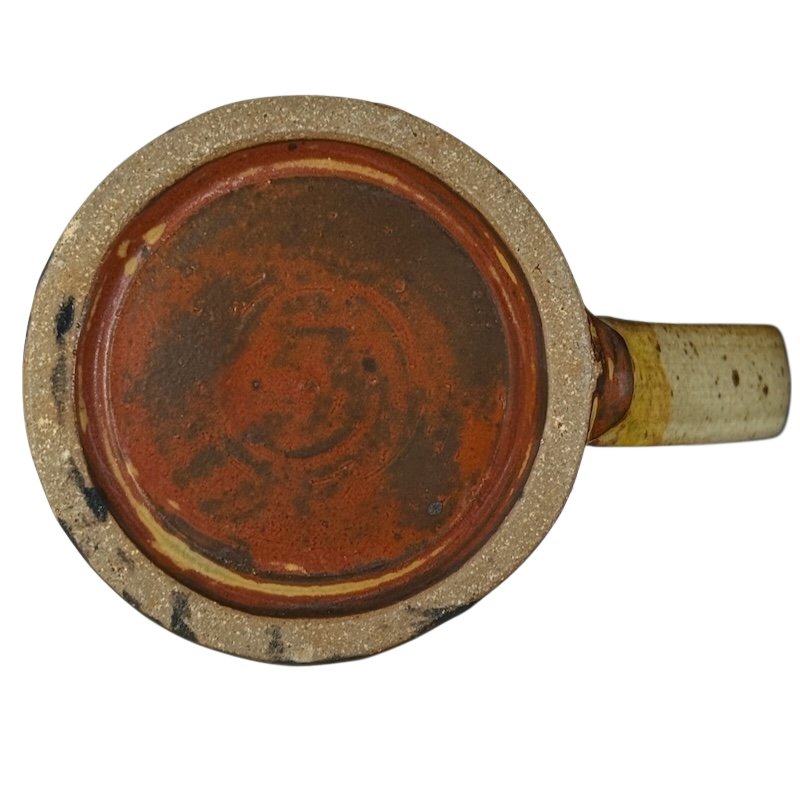 Bottom view of vintage Caffe Pergolesi mug showing rustic ceramic base and handle